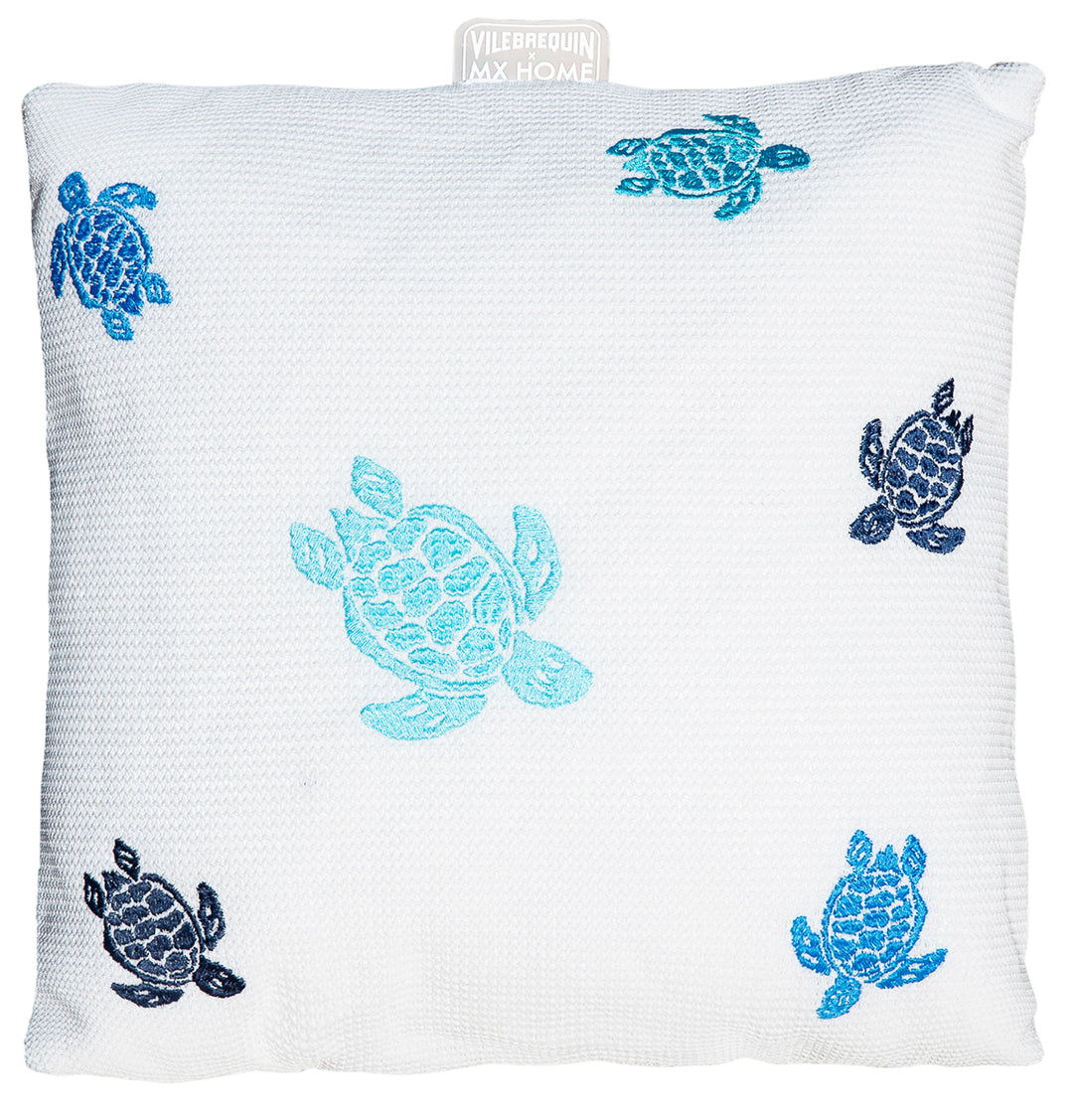 White Vilebrequin cushion with multicolored turtle embroidery, ideal for premium outdoor decor. Luxurious decorative accessory for outdoor furniture, designed to enhance elegant outdoor spaces.
